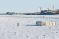 A man walks on the ice of the border river Amur towards Russia from a closed hole. State border. International customs