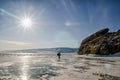 Man walks on the ice of lake Baikal in sunny day Royalty Free Stock Photo