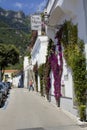 Man walks onto a sidewalk in a street scene from Positano, Amalfi Coast, Italy. Royalty Free Stock Photo