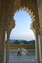 A man walks past an arch of the Mausoleum of Mohammed V on the Y