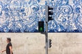 Man walks past the blue and white tiles azulejo on Carmo Church in Porto, Portugal