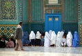 A man walks past a group of women and children outside the Blue Mosque in Mazar i Sharif, Afghanistan