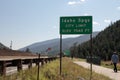 Man Walks Past I-70 Idaho Springs City Limit Elevation Sign