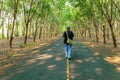 Man walks on a road in forest