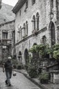 Man walks by in a street of the medieval French village of Saint-Guilhem-le-DÃÂ©sert