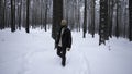 Man walks stylishly in winter forest. Media. Fashionable shot of stylish man walking in winter forest. Winter fashion Royalty Free Stock Photo