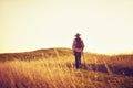 Man walks into the sunset on a hill Royalty Free Stock Photo