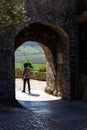 Man Walks Through Castle Tunnel Passage