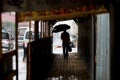 A man walks under an umbrella during the rain, having his face off the camera Royalty Free Stock Photo