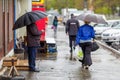 A man walks under an umbrella during the rain, having his face off the camera Royalty Free Stock Photo