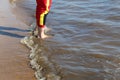 A man walks on the water along the shore with bare feet Royalty Free Stock Photo