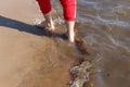 A man walks on the water along the shore with bare feet Royalty Free Stock Photo