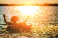 A man ware hat and he is on swim tube in the water. He is hands up to make water splash. Royalty Free Stock Photo