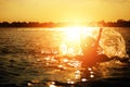 A man ware hat and he is on swim tube in the water. He is hands up to make water splash. Royalty Free Stock Photo