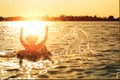 A man ware hat and he is on swim tube in the water. He is hands up to make water splash. Royalty Free Stock Photo