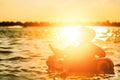 A man ware hat and he is on swim tube in the water. He is hands up to make water splash. Royalty Free Stock Photo