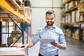 Man warehouse worker with a tablet. Royalty Free Stock Photo