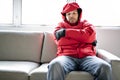 A Man With Warm Clothing Feeling The Cold Inside House on the sofa Royalty Free Stock Photo