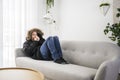 Man With Warm Clothing Feeling The Cold Inside House on the sofa blow the nose Royalty Free Stock Photo