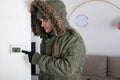 Man In Warm Clothing Pointing To Current Room Temperature Royalty Free Stock Photo