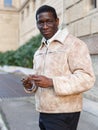 Man in warm jacket reading guidebook