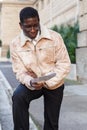 Man in warm jacket reading guidebook