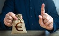 A man warns with his finger offering a euro money bag. Bad credit history.