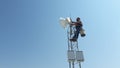 A man was hiking an antenna for installing the communication line