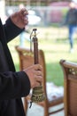 The man was holding a zurna in his hand . A man playing zurna traditional instrument in wedding