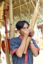 A man was playing a kind of reed mouth organ in northeastern Thailand called Khan.