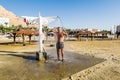 A man is washed in the shower on the beach, dead sea, Israel Royalty Free Stock Photo