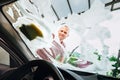 Man washes car front windows with soap foam Royalty Free Stock Photo