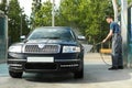 A man washes a car in a manual car wash Royalty Free Stock Photo
