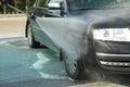 A man washes a car a manual car wash. Clear car
