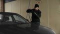 Man Washes Car in Self-Serve Car Wash (Winter)