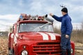A man washes the fire truck