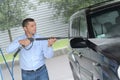 Man washes car at carwash using karcher