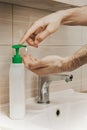 A man washes his hands with liquid soap under running water in the bathroom at home Royalty Free Stock Photo