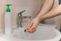 A man washes his hands with liquid soap under running water in the bathroom at home Royalty Free Stock Photo