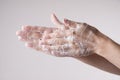 A man washes his hands with soap and water