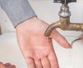 A man washes his hands with tap water from an old authentic copper tap, summer, outdoor, close-up Royalty Free Stock Photo