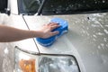 Man washing  car with blue sponge Royalty Free Stock Photo