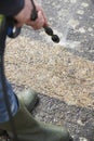 Man Washing Concrete Path With Pressure Washer