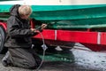 Man washing dirty boat hull with pressure washer Royalty Free Stock Photo