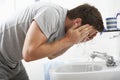 Man Washing Face In Bathroom Sink Royalty Free Stock Photo