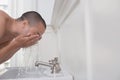 Man Washing Face In Sink