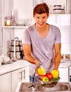 Man washing fruit at kitchen Royalty Free Stock Photo