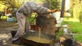 Man is washing fruit marc from distillation apparatus after cooking and making domest apparatus, he making domestic alcohol liquor