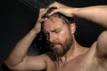 Man washing hair in bath. Guy bathing shower head in bathtub. Face in foam in shower. Bathing man taking shower. Close Royalty Free Stock Photo