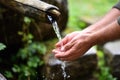 Man washing hands in fresh, cold water of mountain spri Royalty Free Stock Photo